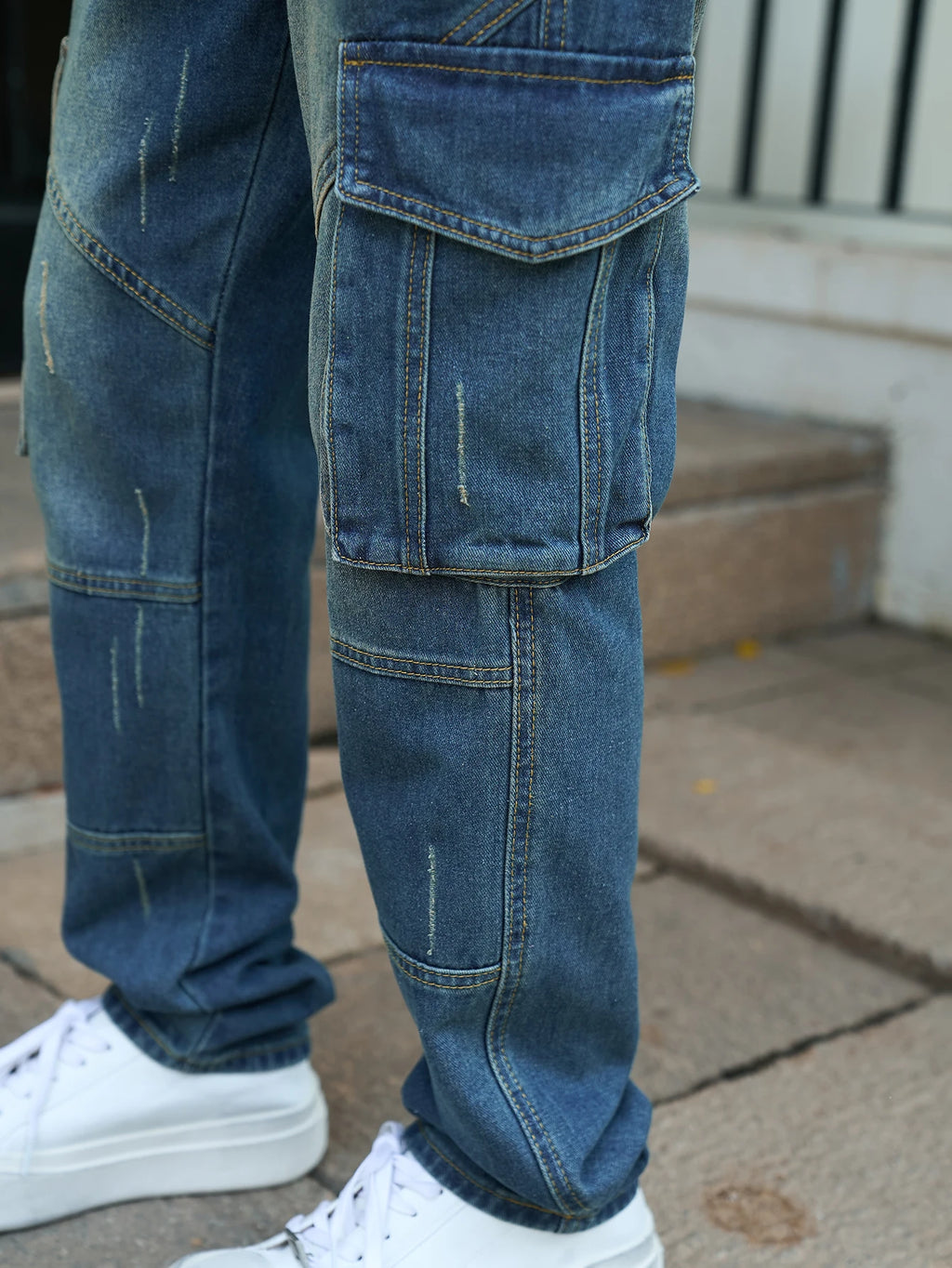 Men’s trendy streetwear: straight-leg, non-stretch, multi-pocket, dark-colored denim jeans.